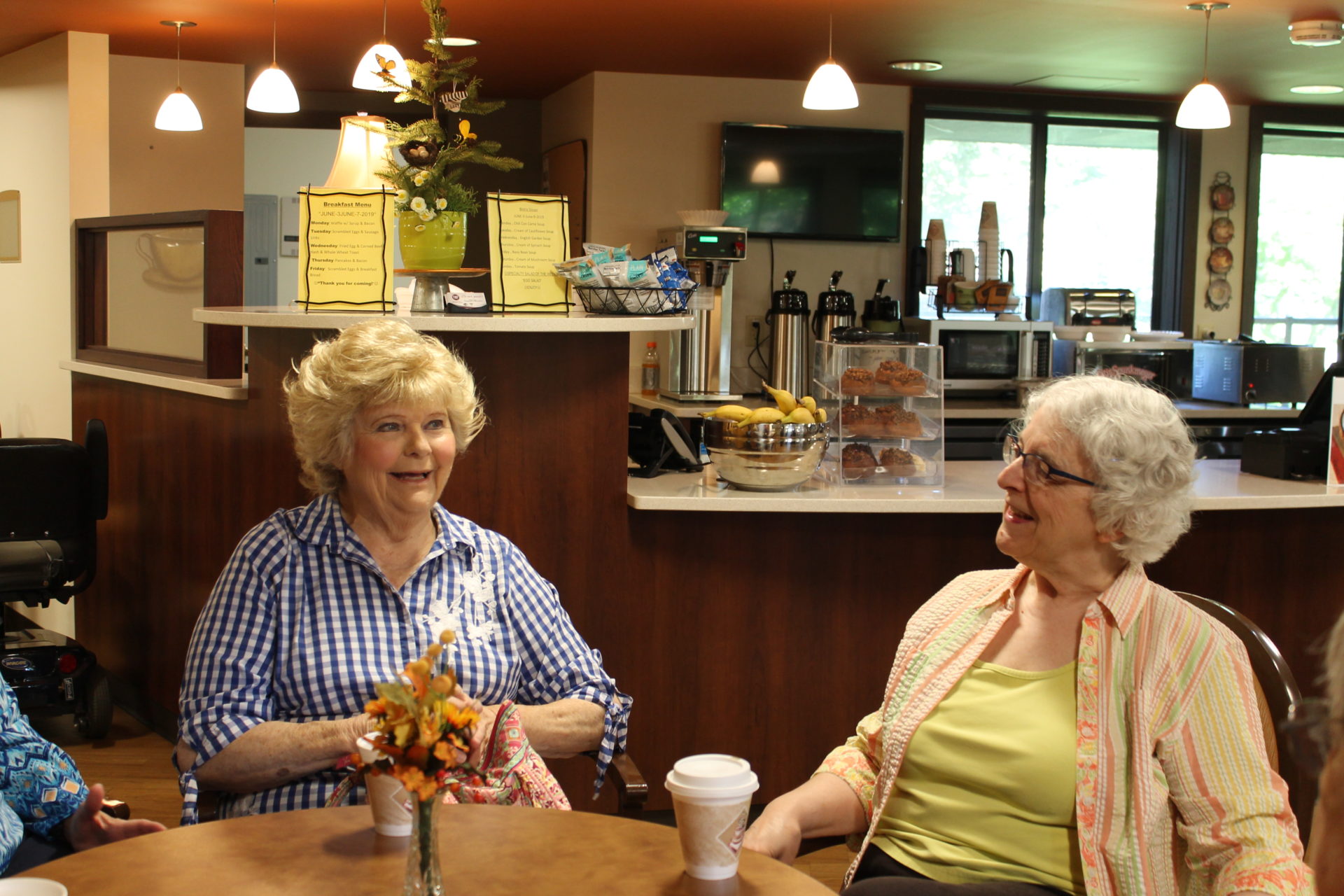 Two people talking at a table.