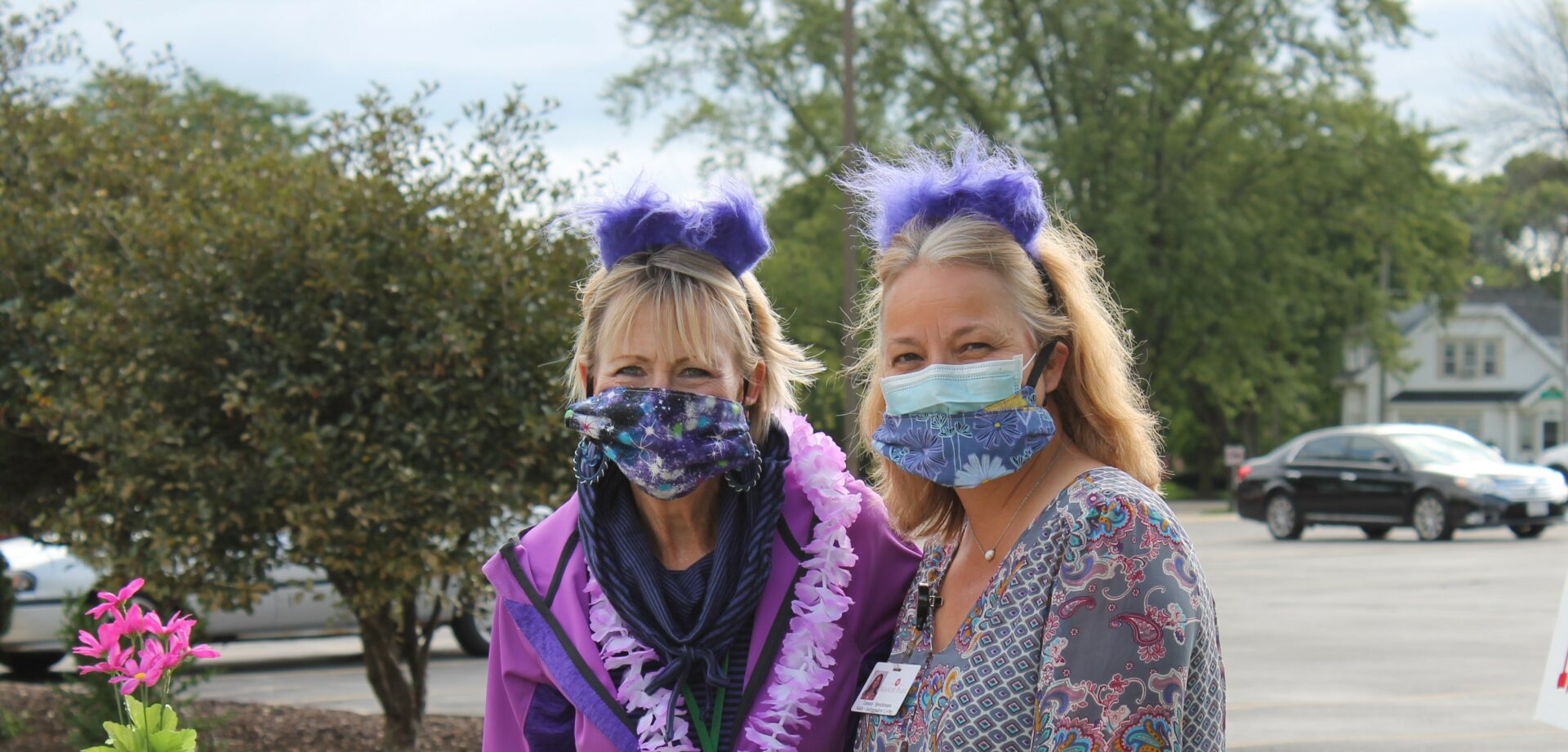 Two ladies smiling in masks.