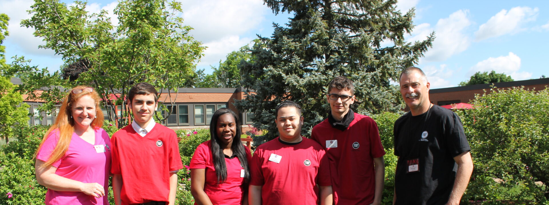 Volunteers smiling together outside VMP Milwaukee.