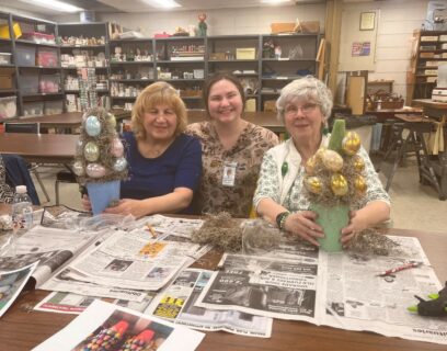 VMP Senior Community Club senior women holding Easter trees with eggs they created in their Easter craft class